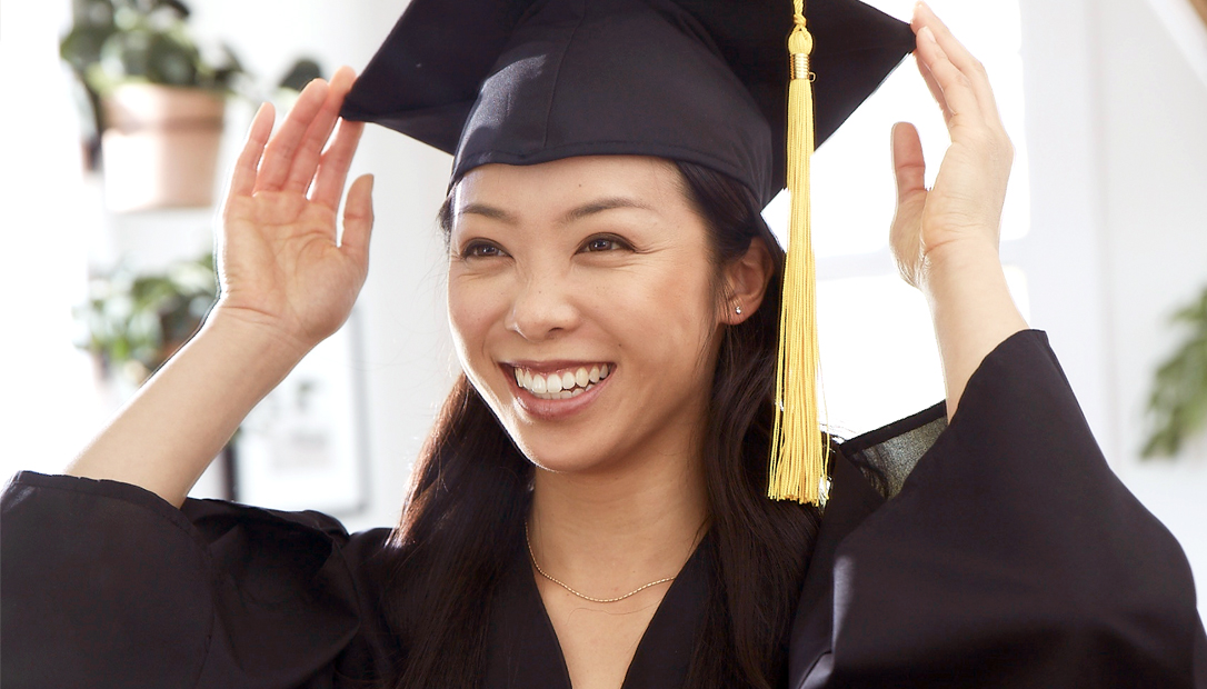female graduate wearing cap and gown