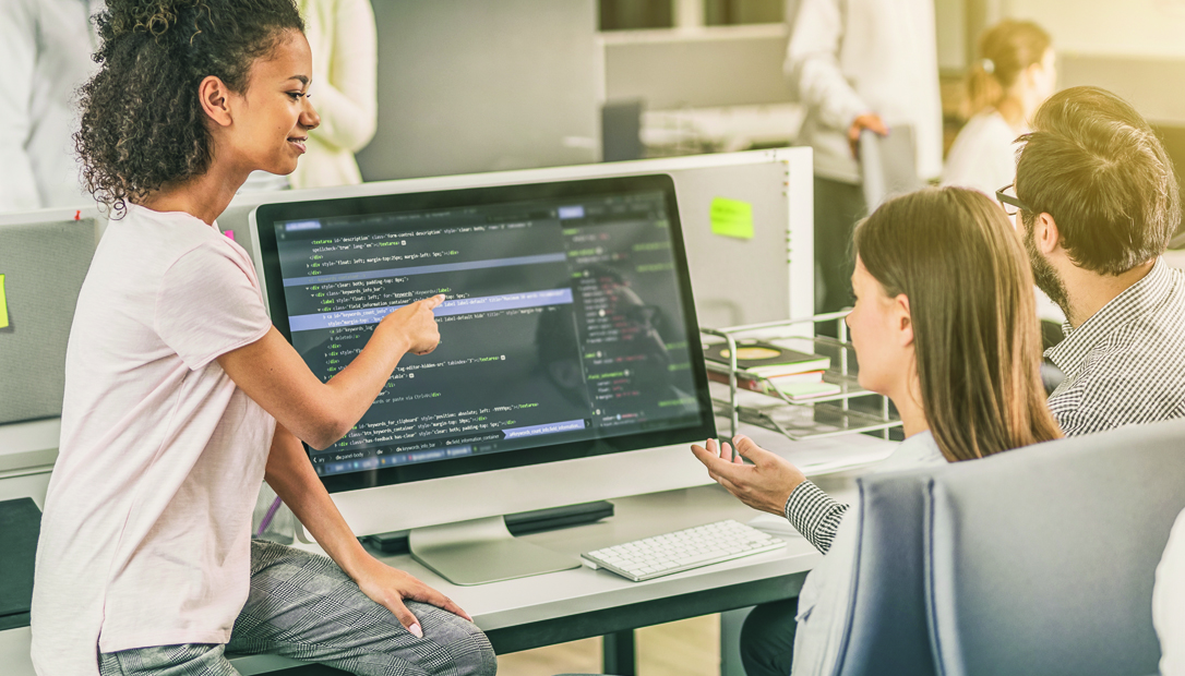 three people looking at code
