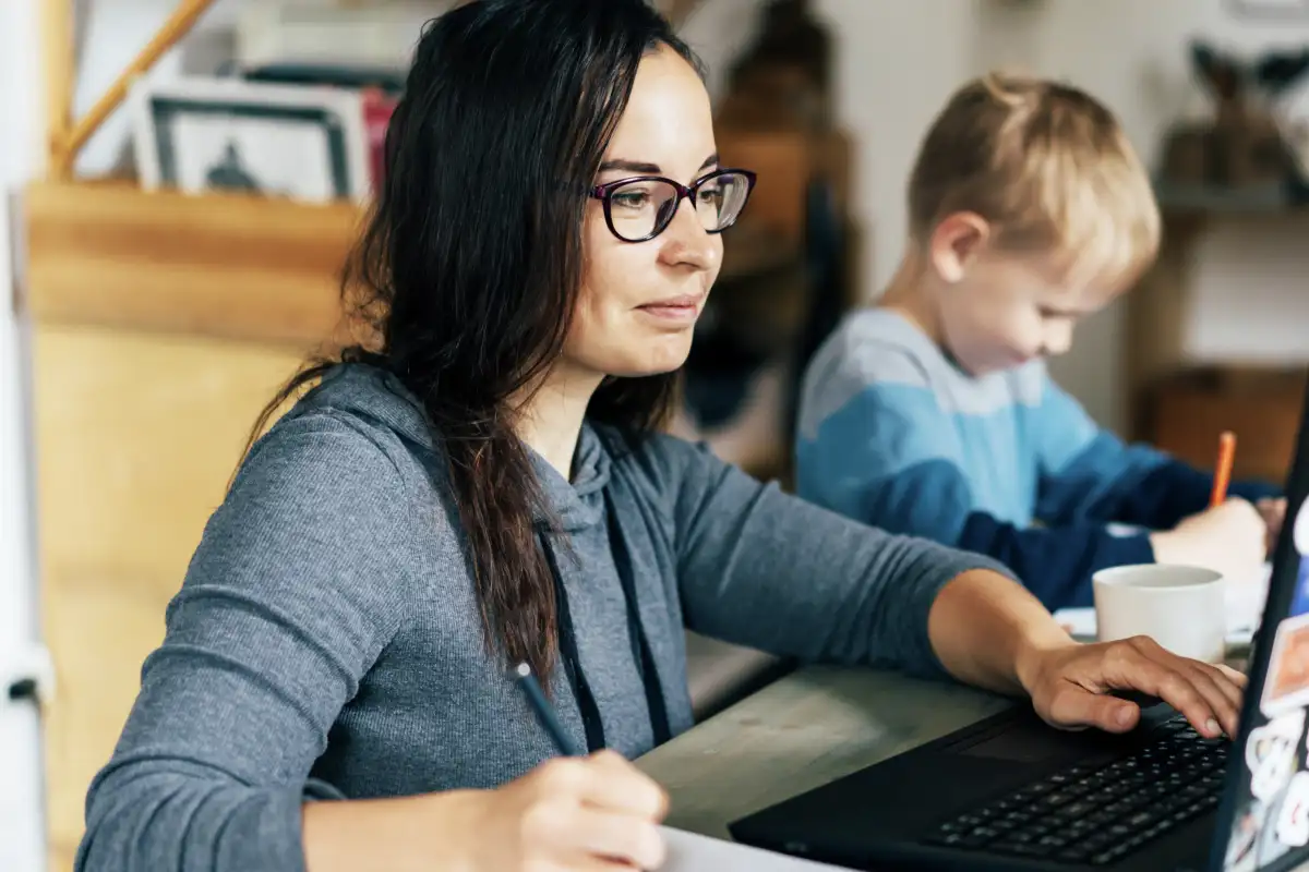 Female working adult learner doing classwork on her laptop at her ...